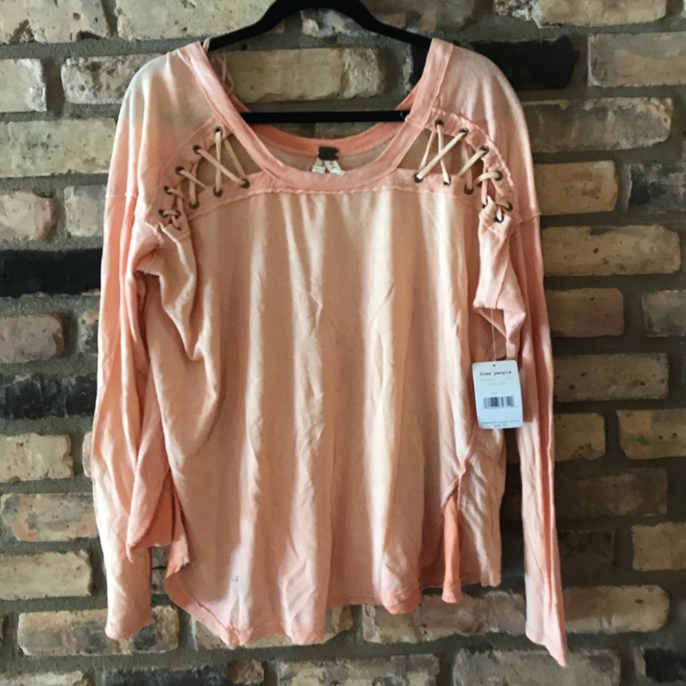 L free people pink sweatshirt with tag on it.